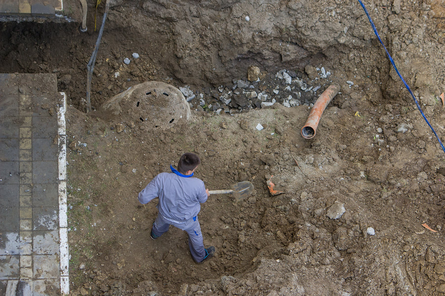 A man repairing the septic pipe